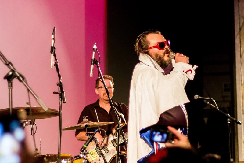 Singer performing on stage under coloured lights (photo 8 of 14)