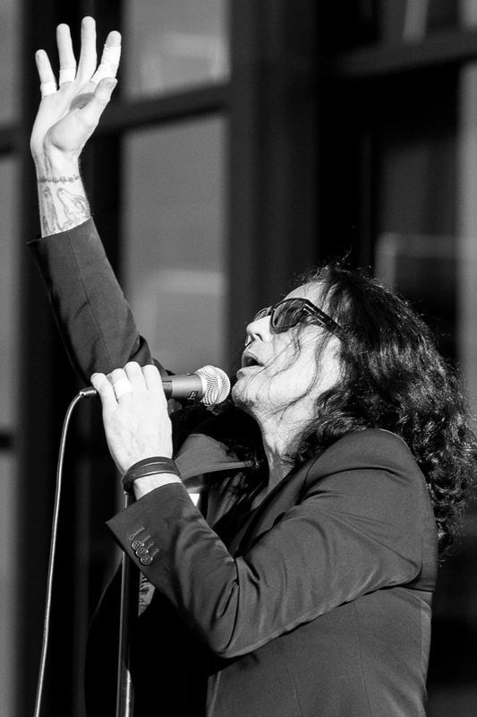 Singer performing on stage under coloured lights (photo 13 of 14)