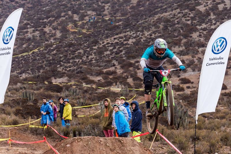 Mountain bike rider jumping a dirt kicker at an enduro race in Chile (photo 2 of 19)