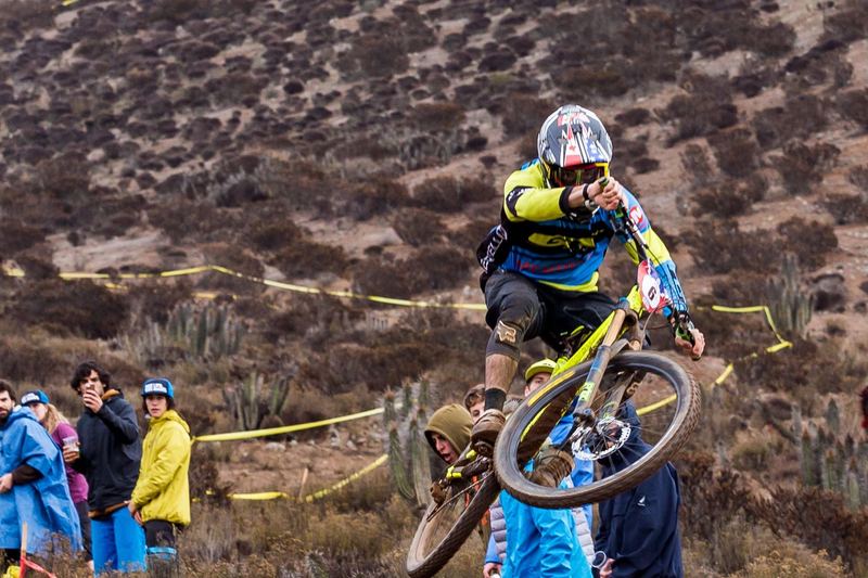 Mountain bike rider jumping a dirt kicker at an enduro race in Chile (photo 3 of 19)