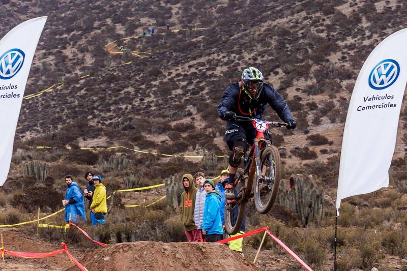 Mountain bike rider jumping a dirt kicker at an enduro race in Chile (photo 4 of 19)