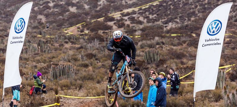 Mountain bike rider jumping a dirt kicker at an enduro race in Chile (photo 6 of 19)