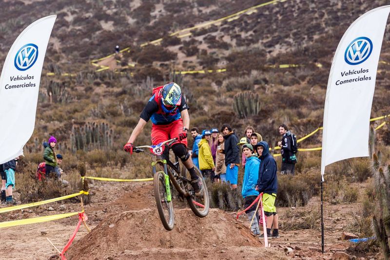 Mountain bike rider jumping a dirt kicker at an enduro race in Chile (photo 7 of 19)