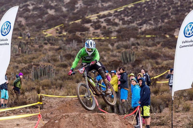 Mountain bike rider jumping a dirt kicker at an enduro race in Chile (photo 8 of 19)