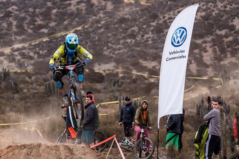 Mountain bike rider jumping a dirt kicker at an enduro race in Chile (photo 13 of 19)