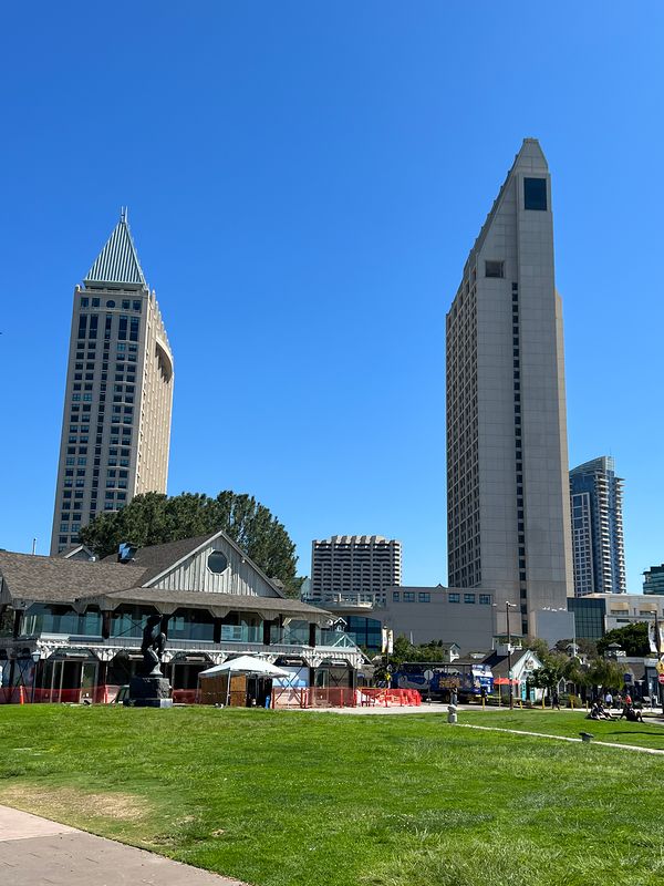 Two San Diego towers seen across the grass of Embarcadero Marina Park (photo 6 of 7)