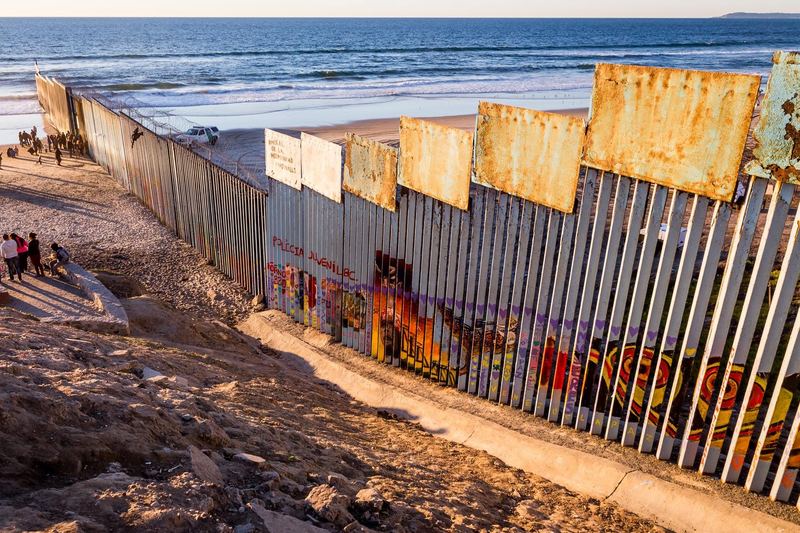 The border fence running into the Pacific at Playas de Tijuana at sunset (photo 4 of 17)