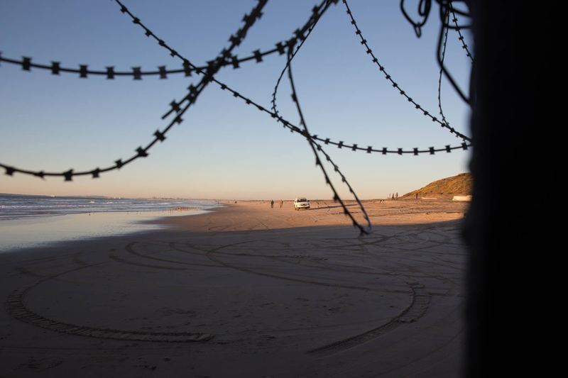 The border fence running into the Pacific at Playas de Tijuana at sunset (photo 7 of 17)